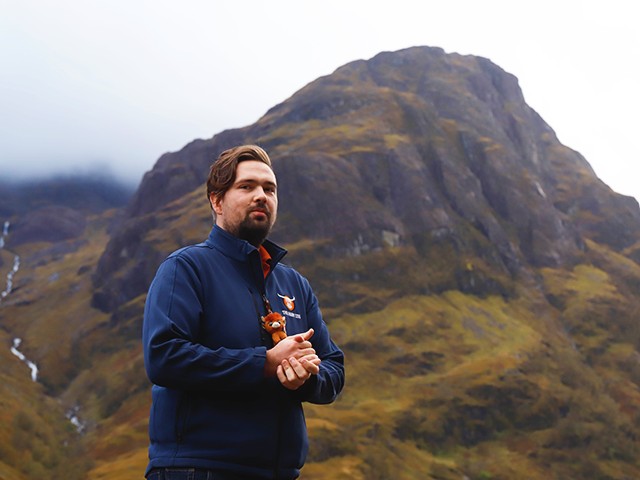 a man standing on a rocky hill