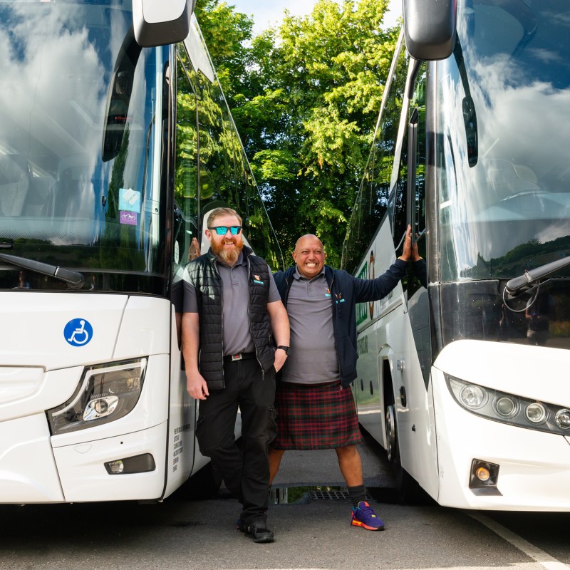 Hairy Coo driver guides between 2 Hairy Coo coaches