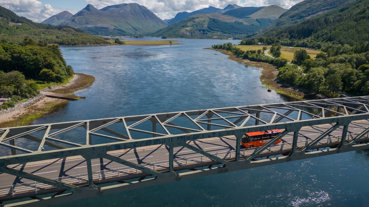 The Hairy Coo coach going across Ballachulish Bridge between Loch Leven and Loch Linnhe