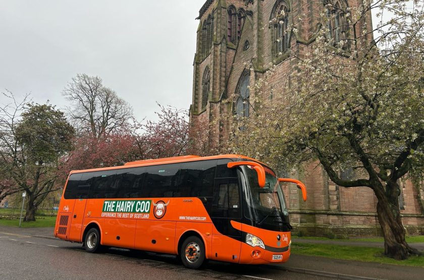 A Hairy Coo orange coach at the meeting point in Inverness - Inverness Cathedral on Ardross Street