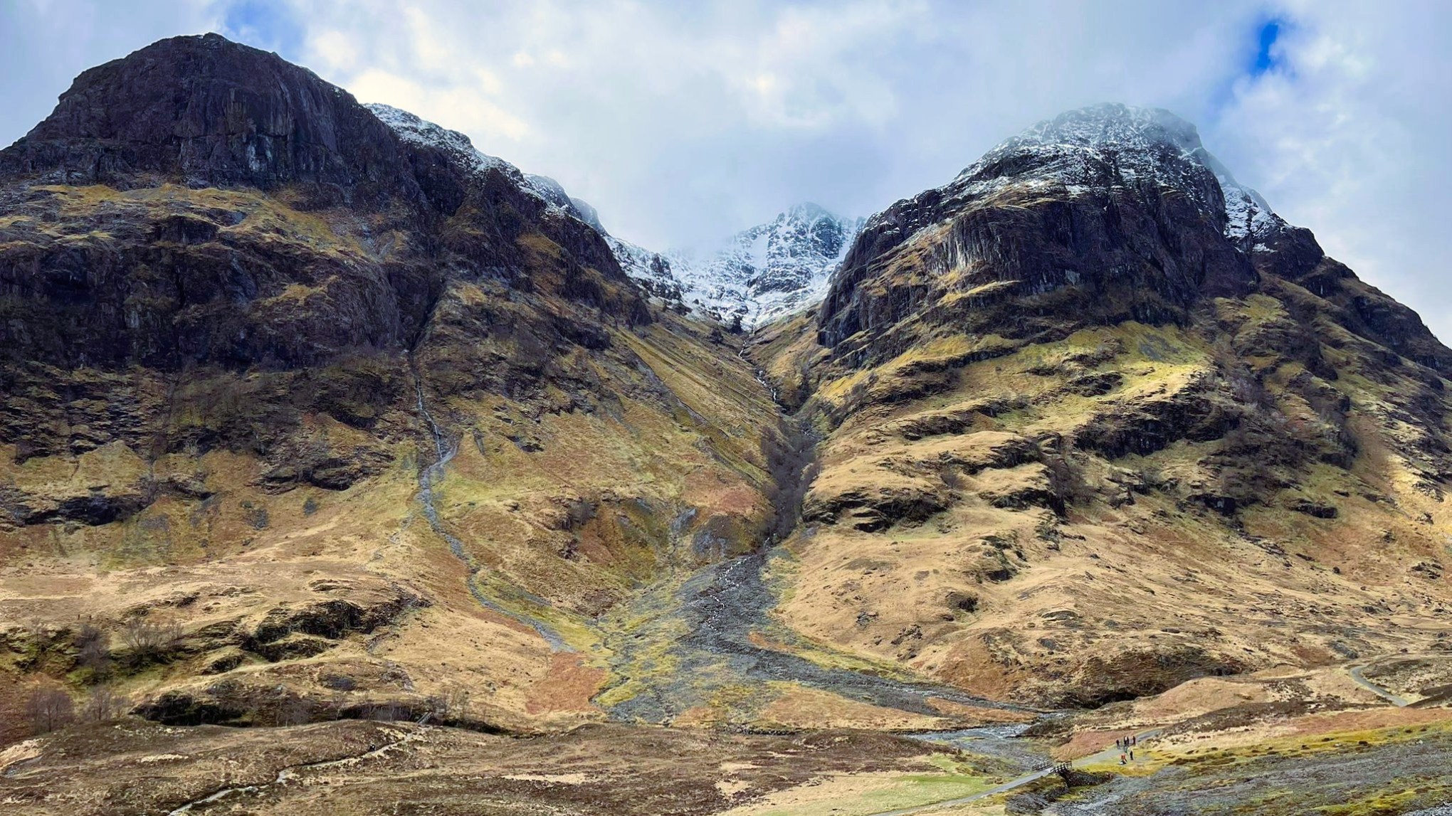 Mountains in the Scottish Highlands viewed on a Hairy Coo tour with snow-capped peaks.