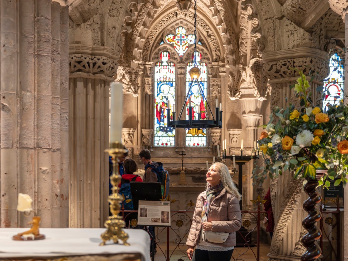 A lady enjoying the ornate stonework to be found inside Rosslyn Chapel