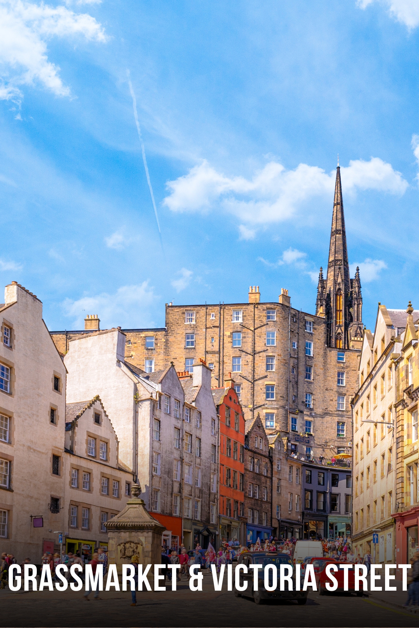 Historic street with colorful buildings and a church spire under a blue sky.